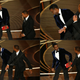 This combination of pictures created on March 28, 2022 shows US actor Will Smith (R) approaches US actor Chris Rock onstage,and US actor Will Smith (R) slaps US actor Chris Rock onstage, during the 94th Oscars at the Dolby Theatre in Hollywood, California on March 27, 2022. (Photo by Robyn Beck / AFP) (Photo by ROBYN BECK/AFP via Getty Images)